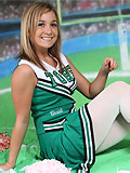 Hot sporty girl in cheerleaders uniform and shiny white tights